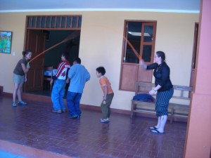 Crystal and Lisa playing jump rope with the orphans in Peru