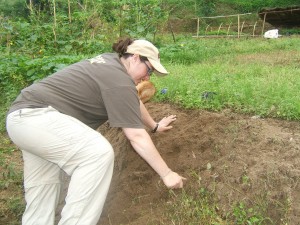 Crystal helping weed a local farmers field in Kaule, Nepal